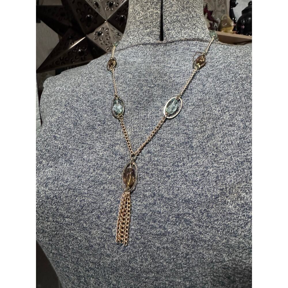 Gold tone with blue and amber colored accented.
